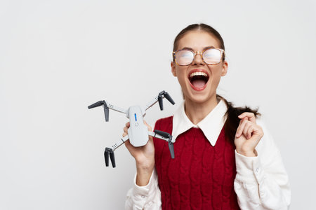 girl holding a drone, excited expression, white background, modern technology, enthusiasm,...
