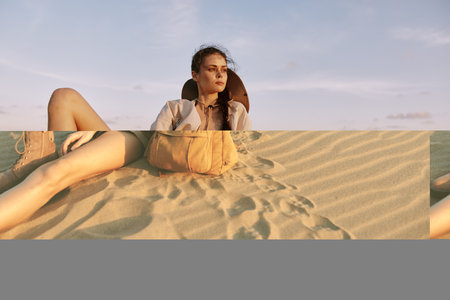 Solitary woman enjoying scenic view from sand dune summit with backpack on her lap in peaceful desert settingの写真素材