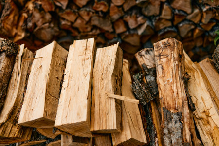 stack of various wooden planks and logs in rustic outdoor setting