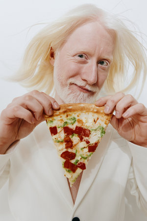 joyful man holding a slice of pizza, white suit, blonde hair, smiling expression, food photography, bright background, colorful toppings, fun dining concept, creative food artの写真素材