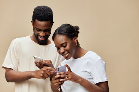 A joyful couple engaged with their smartphones, showcasing technology s role in modern...