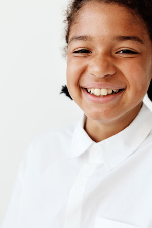 cheerful young boy in white shirt exuding confidence and joyの写真素材