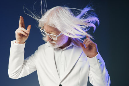 elderly man with long white hair dancing in white suit, vibrant background, expressive pose, energetic vibe, stylish and modern appearance, conveying joy and freedom through movementの写真素材