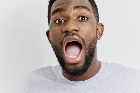Surprised man with open mouth reacts to unexpected eventの写真素材