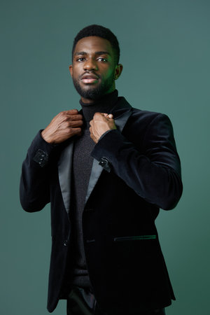 Elegant young man in black jacket and turtleneck exudes confidence and sophisticationの写真素材