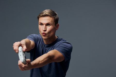 Full body image of a young Caucasian man with short brown hair, wearing a casual blue t-shirt,...