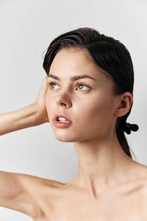 Portrait of a young woman with a natural look, soft lighting, and a neutral background, emphasizing her beauty and expression Elegant and serene appearanceの写真素材