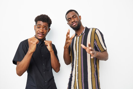 Two confident African American men posing together, expressing joy and camaraderie. Their vibrant...
