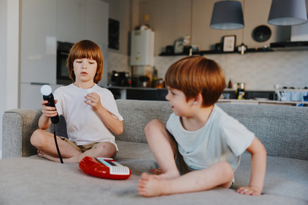 Playful boys engaged in creative activities indoors, showcasing their joy and imagination through...