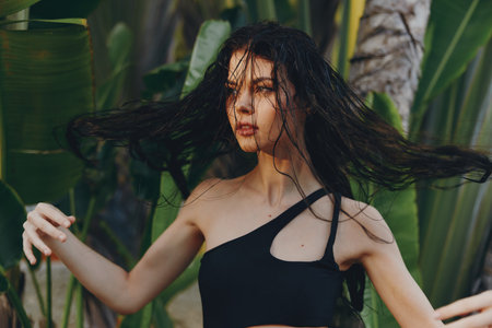 Woman Standing in Field with Hair Blowing in the Wind, Black Top, Nature Landscape Portraitの写真素材