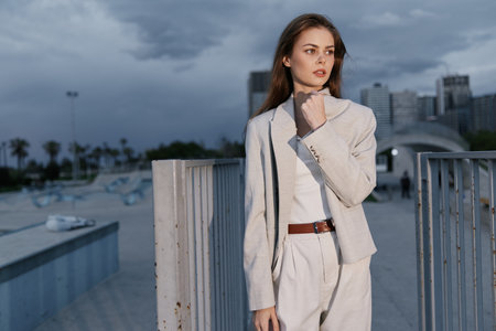 Confident woman in a light business suit against a modern cityscape, showcasing a professional and...