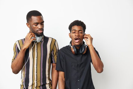 Two black men enjoying music together, showcasing friendship, laughter, and relaxed vibes. Perfect for themes of joy and connection through music.の写真素材