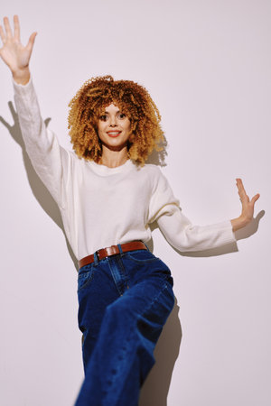 Fashion portrait of a stylish woman posing with enthusiasm against a plain white background,...