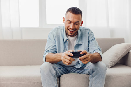 Smiling man enjoying a digital detox while playing video games, reflecting emotional minimalism and...