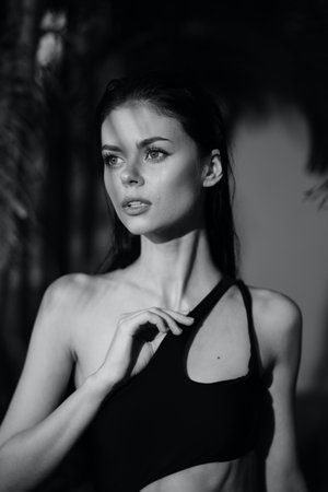 Elegant woman in retro swimsuit posing for vintage black and white photo on the beachの写真素材