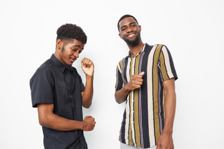 Happy African American men enjoying a fun moment together, showcasing friendship and joy. Perfect for themes of diversity and positivity in social settings.の写真素材