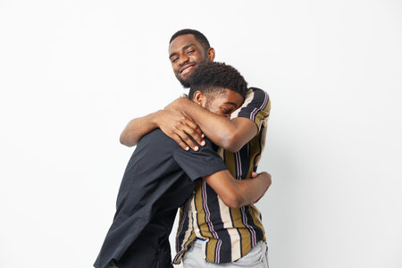 Embracing black men sharing a joyful moment, showcasing love and connection in a vibrant setting...