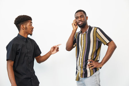 Two African American men engaged in a conversation, illustrating friendship and communication in a...