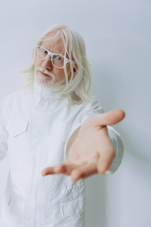 elderly man with long white hair and glasses offering hand, white background, inviting gesture, soft...