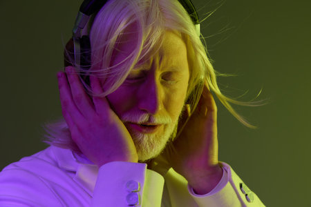 Elderly man enjoying music with headphones, soft colors, vibrant atmosphere, serene expression,...