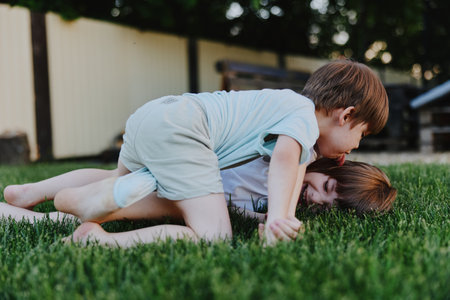 Playing children enjoying fun outdoors, showing joy and friendship in a vibrant green setting,...