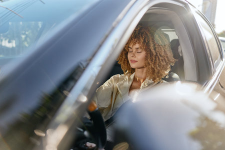 Calm woman driving a car with eyes closed, curly hair, casual beige jacket, soft sunlight, peaceful...