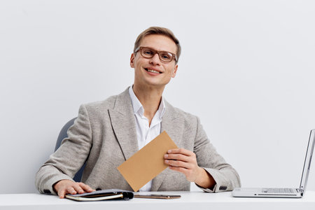 smiling man using laptop casual wear eyeglasses sitting at table work remote video call white...