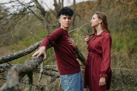 A candid scene features two young adults in a rustic outdoor setting, emphasizing authenticity and credibility through natural pose and sincere interaction.の写真素材