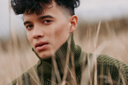 Portrait of a young person in a knit turtleneck, captured with natural light and an honest, unposed...