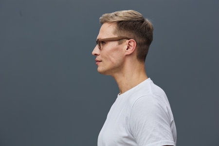 Profile view thoughtful young man wear glasses white t-shirt isolated grey background digital nomad...