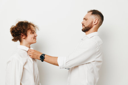 Professional man assists a colleague on an isolated colored background, expressing leadership, confidence, and positive emotions in a focused business moment.の写真素材