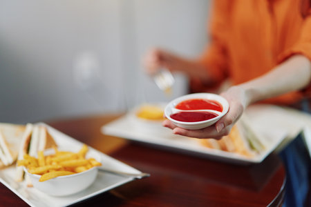 Delicious fast food meal with fries and sauces, highlighting the joy of casual dining, showcasing vibrant colors and a relaxed atmosphereの写真素材