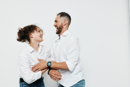 A man and a woman share a warm moment, showing confident joy and engagement against an isolated colored background.の写真素材