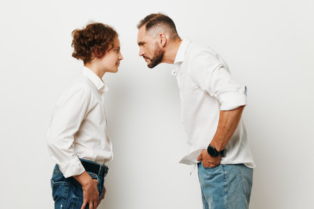 A professional man and colleague face off on an isolated white background, conveying tension, focus, and competitive emotion in a scene.の写真素材