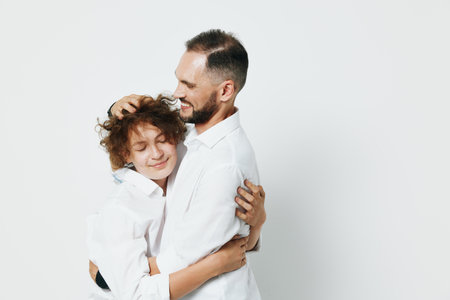 A professional businessman shares a warm embrace, expressing trust and care. Isolated on a clean colored background, the moment captures emotion and connection.の写真素材