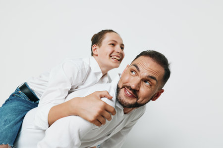 A man with a cheerful expression on a bright background conveys confidence and warmth, blending focus with approachable humor to tell a scene of leadership and empathy.の写真素材