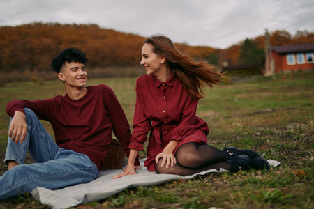 Authentic moment of connection between two friends in a field, candid laughter and natural pose, a scene that conveys trust, comfort, and genuine companionship.の写真素材