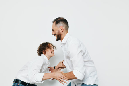 A professional businessman shares a warm moment with a colleague, exuding confidence and ambition against an isolated white background. The scene conveys leadership, approachability, and teamwork inの写真素材