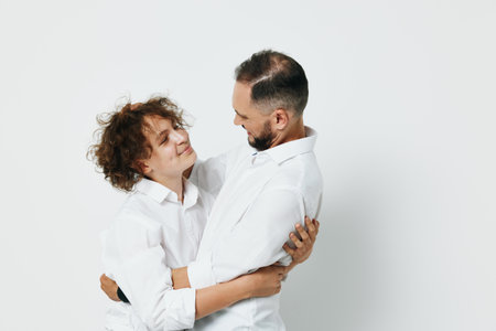 A professional man in business attire shares a warm moment with a colleague, showing confident and...