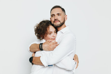 A professional man in a crisp shirt shares a warm embrace, expressing confidence and empathy against...