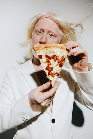 Pizza, food, portrait, person holding, white background, expression A surprised individual presenting a slice of pizza, showcasing toppings, with a light colored suit and tousled hairの写真素材