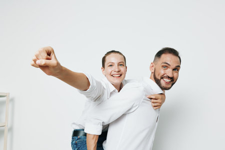 A professional businessman and colleague share a playful moment against an isolated white background, conveying confidence, teamwork, and positive emotion.の写真素材