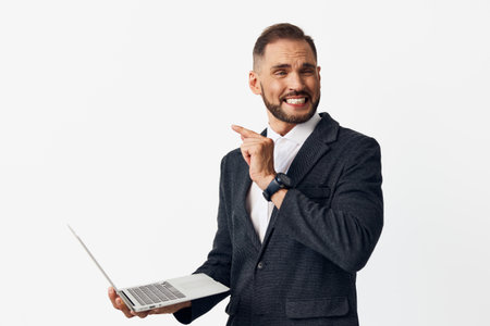Business portrait of a confident man in a smart jacket, displaying a cheerful expression and pointed...