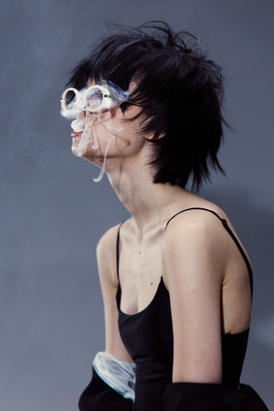 Blurred woman with black hair wearing sunglasses and black tank top, creative double exposure effect...