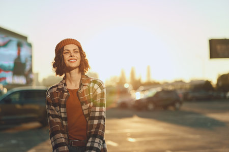 Woman smile candid golden urban beanie plaid lifestyle portrait of a young woman laughing at sunset, showcasing authenticity, candid lifestyle and golden hour glow with mindful living and emotionalの写真素材