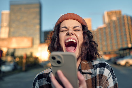 Woman with phone on urban city street, candid laughter and raw emotion captured at golden hour glow;...
