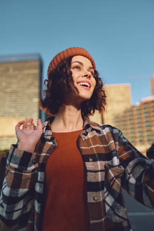 Woman smile in urban portrait at golden hour, candid lifestyle capture with authenticity and joyful expression, golden hour glow and mindful living vibe, emotional storytelling in modern city fashion.の写真素材