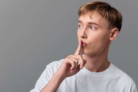 shushing, secrecy, silence, gesture, hush, finger, lips, quiet, A calm moment with a thoughtful figure signaling for silence, inviting focus and discretion in a scene of quiet communication andの写真素材