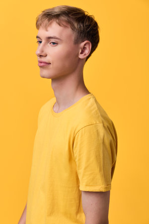 Yellow shirt with side profile in studio lighting for fashion and color study, monochrome...