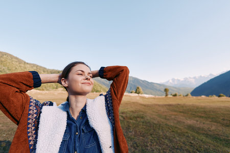 Woman in nature, mountains and meadow, relaxed with eyes closed and smiling. Portrait of happiness,...